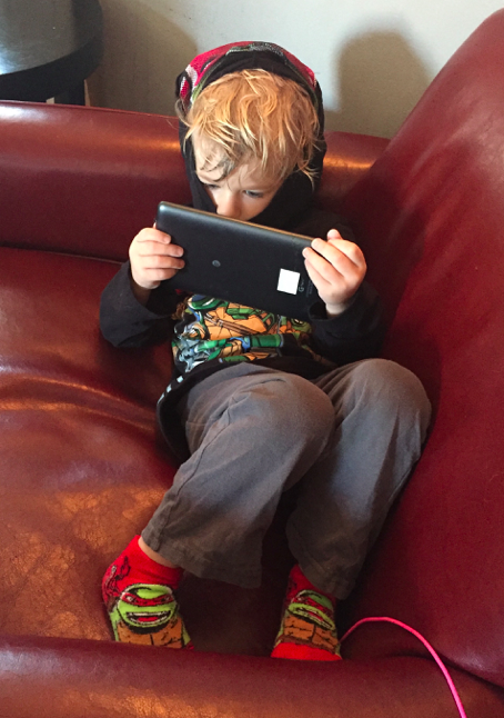 Young Gen Z boy with iPad